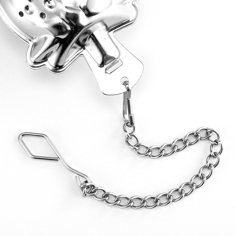 Gold strawberry-shaped tea infuser with a matching saucer and chain Gold strawberry-shaped tea infuser with a matching saucer and chain