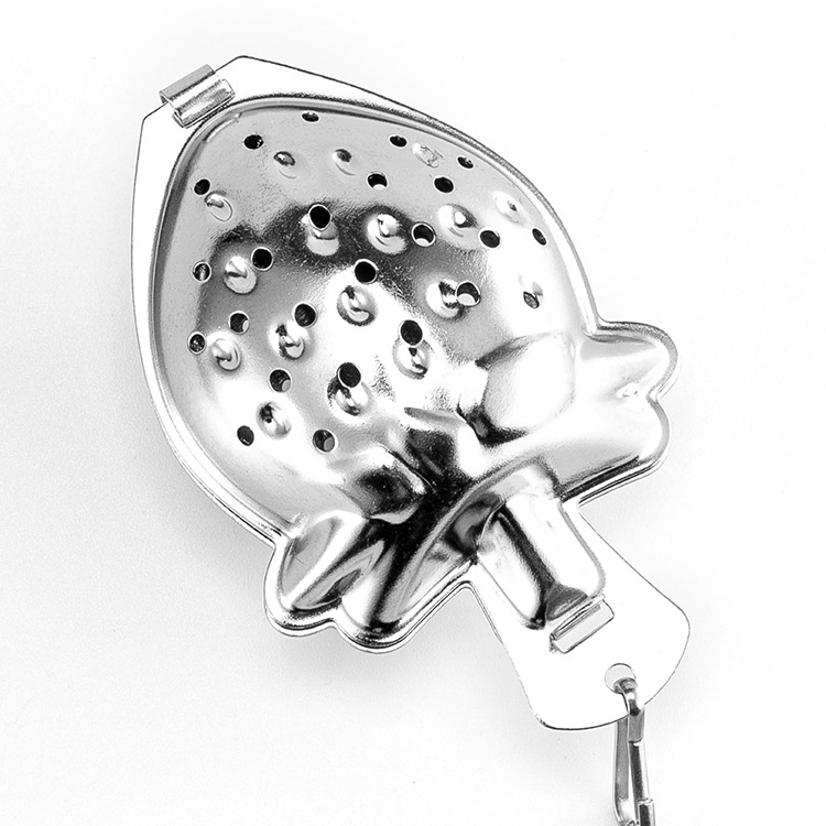 Gold strawberry-shaped tea infuser with a matching saucer and chain Gold strawberry-shaped tea infuser with a matching saucer and chain