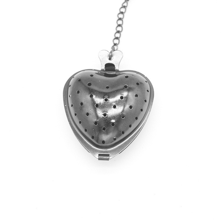 Luxury heart-shaped stainless steel tea infuser with PVD gold finish and precision perforated mesh.