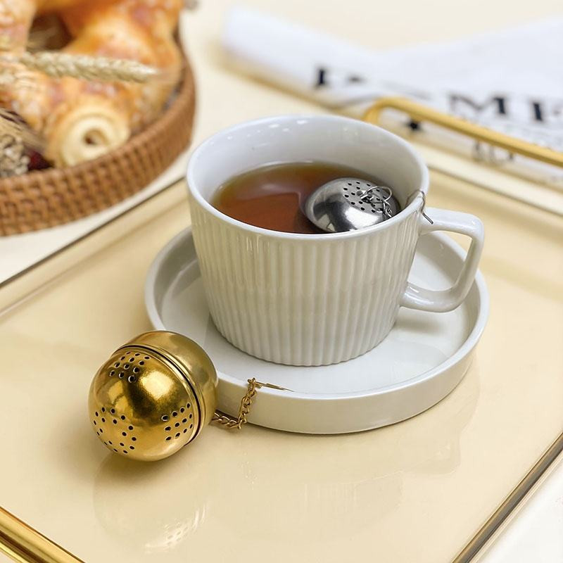 Tea Infuser Egg Ball with matching drip tray catching tea drips Tea Infuser Egg Ball with matching drip tray catching tea drips